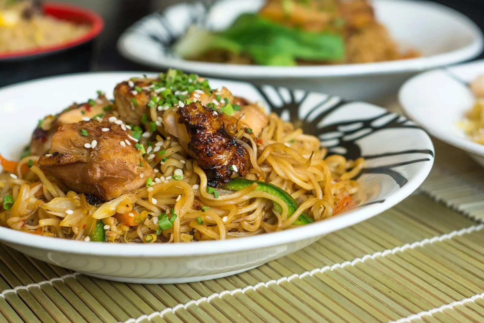 Plate of stir-fried noodles with glazed chicken from the oriental counter